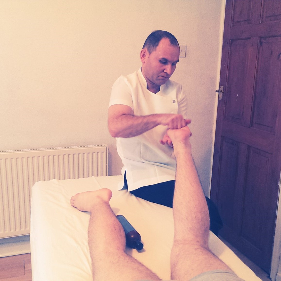 Vasile Zelea massaging the sole of a person